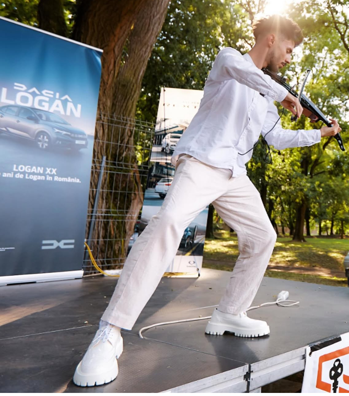 Máté Kozma playing electric violin at outdoor Dacia event